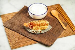 Japanese Deep Fried Shrimp Donburi with Rice, chopsticks and spoon served in bowl isolated on napkin side view of Japanese food photo