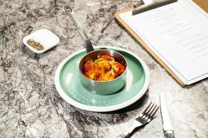 Meatballs with Tomato Sauce, green onion, dip, fork and knife served in plate isolated on marble background side view of hong kong food photo