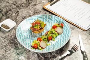 Raw Tuna and Avocado Poke Salad with Sesame In Wonton Crust and Topped with Yuzu Caviar with dip, fork and knife served in plate isolated on marble background side view of hong kong food photo