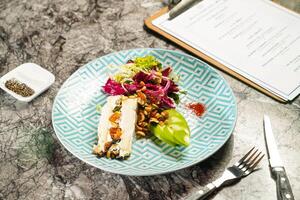 Brie cheese with dried fruit and apple and celery garden salad with dip, fork and knife served in plate isolated on marble background side view of hong kong food photo
