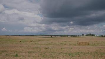 Time lapse field without wheat with clouds video