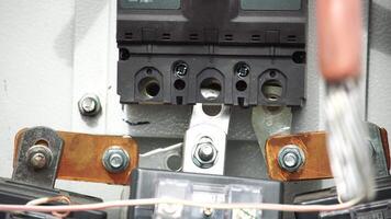 Close-up view of Electrician installing wires, cables into a electricity power shield, fuse box, an industrial electric panel with lots of colorful cables and wires. Power industry concept. video