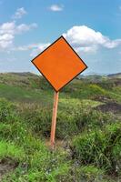 Empty sign on top of hill. Empty sign surrounded by vegetation photo