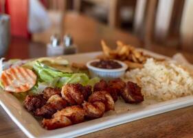 Plate of breaded shrimp with rice on the table with COPY SPACE, menu of breaded shrimp served on wooden table photo
