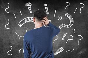 Puzzled man scratching his head isolated. Rear view of confused man scratching head isolated photo
