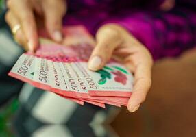 People counting Nicaraguan 500 cordobas banknotes. Hands of woman counting banknotes photo