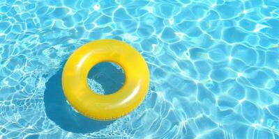 yellow swimming pool ring float in blue water surface photo