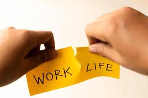 Work Life Balance Copceptual Photo, Hand Tearing Paper with Work and Life Text, Tear it Completely apart photo