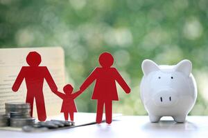 Model family with piggy bank and stack of coins money on natural green background,Save money for prepare in future and family finance concept photo