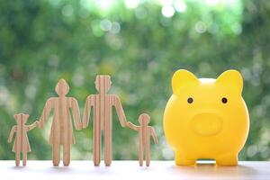 Model family with piggy bank on natural green background,Save money for prepare in future and family finance concept photo
