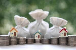 Finance, Model house with money bag on natural green background,Business investment and Save money for prepare in future concept photo
