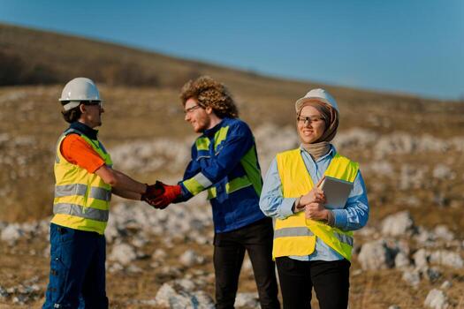 Engineers Collaborating in the Field to Inspect and Optimize Electric Turbines. photo