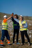 Engineers Collaborating in the Field to Inspect and Optimize Electric Turbines. photo