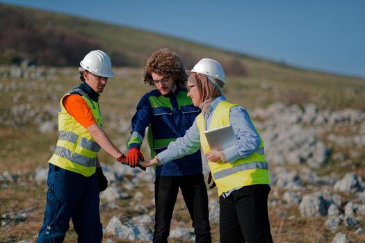 Engineers Collaborating in the Field to Inspect and Optimize Electric Turbines. photo