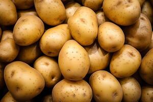 A pile of fresh potato form the background, shown from above photo