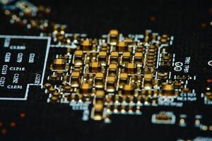 close up of a circuit board with gold and black components photo
