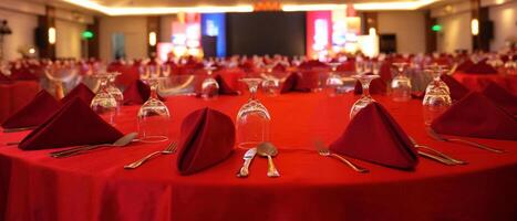 a red table with red cloth and silverware photo
