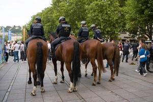 Stuttgart, Germany, 5 July 2024. The Stuttgart Mounted Police in Baden-Wuertenberg. Police officers on horseback patrol the street during sporting events. photo