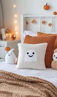 Cozy autumn bedroom adorned with cute ghost pillows and pumpkin decor photo