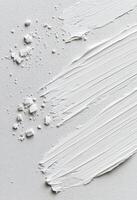 Layers of textured white paint on canvas creating a smooth artistic surface photo