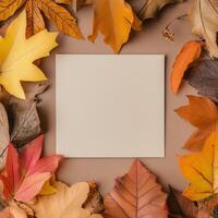 Blank canvas surrounded by colorful autumn leaves on a textured surface photo
