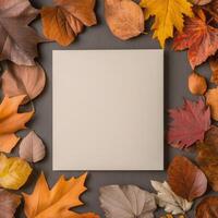 Blank canvas surrounded by colorful autumn leaves on a textured surface photo