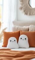 Cozy autumn bedroom featuring cute ghost plush toys on a warm bed photo