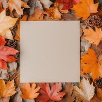 Blank canvas surrounded by colorful autumn leaves on a textured surface photo