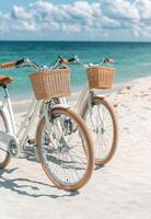 Three bicycles parked on a sandy beach under a leafy tree on a sunny day photo