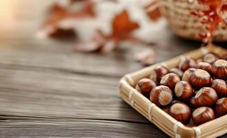Freshly harvested hazelnuts on a textured wooden table with autumn leaves in the background photo