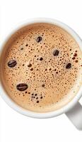 Hot coffee in a white cup with coffee beans floating on the surface photo