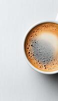 Hot coffee in a white cup with coffee beans floating on the surface photo