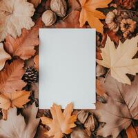 Blank card surrounded by colorful autumn leaves on the ground in a forest setting photo