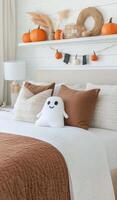 Cozy autumn bedroom decor with plush ghost and pumpkins on display photo