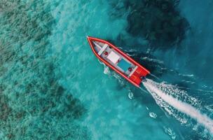 Red Boat Cruising Over Turquoise Waters in a Tropical Paradise photo