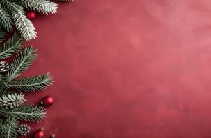 Festive Evergreen Branches and Red Ornaments on Rich Burgundy Background photo
