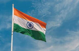 Indian National Flag Waving Against Clear Blue Sky During Daytime photo