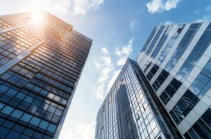 Sunlight Shining Down Between Skyscrapers in Urban Setting photo