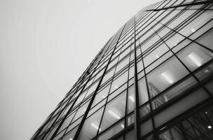 Modern Glass Building Reaching Sky Under Cloudy Sky photo