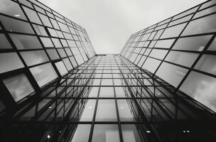 Modern Glass Building Reaching Sky Under Cloudy Sky photo