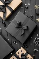 Elegant Black And Gold Wrapped Gifts With Satin Ribbons On Dark Background photo