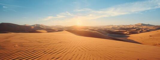 Sunlit Desert Dunes With Lush Grass Clusters Under Clear Blue Sky photo