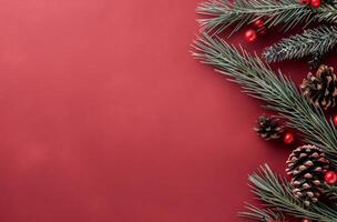 Festive Pine Branches With Red Ornaments and Pine Cones on a Rich Red Background photo