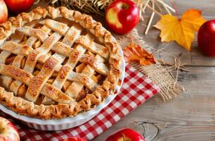 Freshly Baked Apple Pie Surrounded by Red Apples and Autumn Decor photo