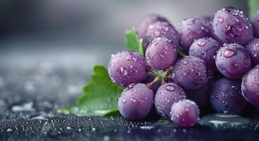 Fresh Grapes With Water Droplets on Dark Surface photo