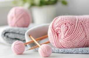 Pink Yarn Ball and Knitting Needles With Soft Knit Fabric photo