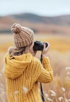 Young Woman Capturing Nature With Camera in Autumn Field photo