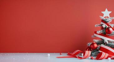 Festively Decorated Mini Christmas Tree With Red Ornaments and Ribbons on a Red Background photo