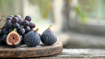 Fresh Grapes and Figs on Wooden Cutting Board With Frost in Natural Light photo