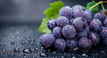 Fresh Grapes With Water Droplets on Dark Surface photo
